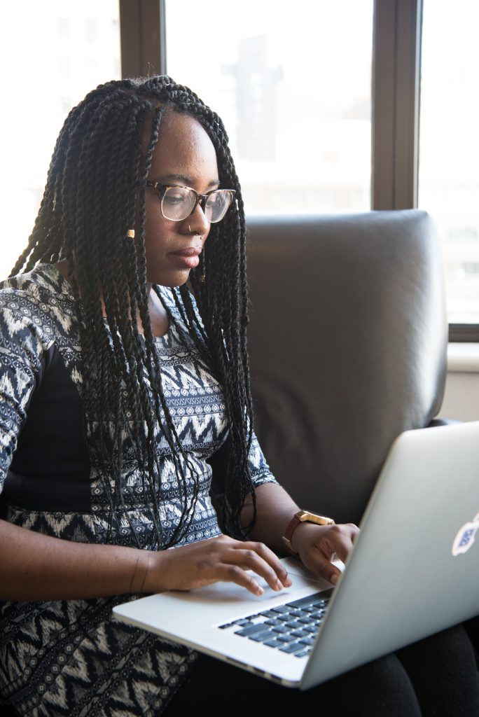 ATIO Translator Global Translation Blog Post Image: Woman of color working on a laptop.